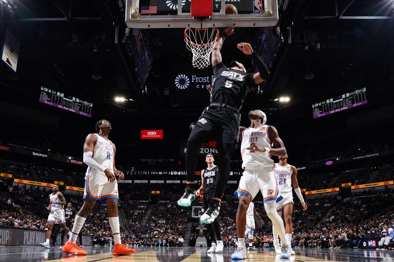 SAN ANTONIO, TX - NOVEMBER 19: Stephon Castle #5 of the San Antonio Spurs dunks the ball during the game against the Oklahoma City Thunder during the Emirates NBA Cup game on November 19, 2024 at the Frost Bank Center in San Antonio, Texas. NOTE TO USER: User expressly acknowledges and agrees that, by downloading and or using this photograph, user is consenting to the terms and conditions of the Getty Images License Agreement. Mandatory Copyright Notice: Copyright 2024 NBAE (Photos by Darren Carroll/NBAE via Getty Images)