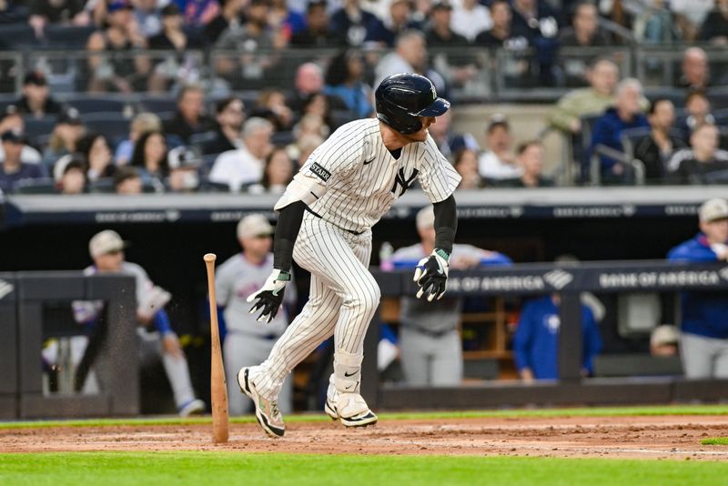 May 16, 2025; Bronx, New York, USA; New York Yankees outfielder Cody Bellinger (35) hits an infield single against the New York Mets during the third inning at Yankee Stadium. Mandatory Credit: John Jones-Imagn Images