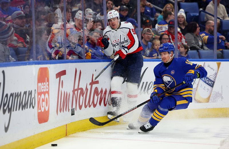 Apr 11, 2024; Buffalo, New York, USA;  Buffalo Sabres defenseman Henri Jokiharju (10) watches the puck after Washington Capitals right wing Nicolas Aube-Kubel (96) clears the puck from behind the net during the first period at KeyBank Center. Mandatory Credit: Timothy T. Ludwig-USA TODAY Sports