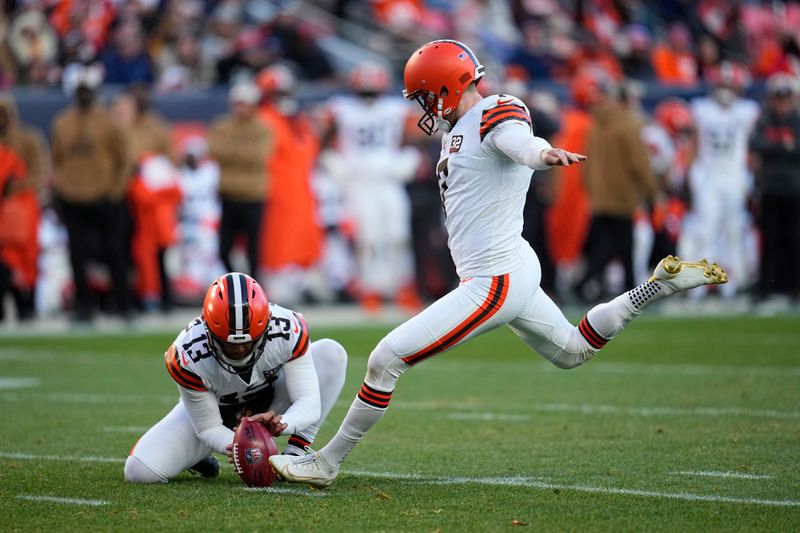 Cleveland Browns place-kicker Dustin Hopkins, right, makes a 24-yard field goal as Corey Bojorquez (13) defends during the first half of an NFL football game against the Denver Broncos on Sunday, Nov. 26, 2023, in Denver. (AP Photo/Jack Dempsey)