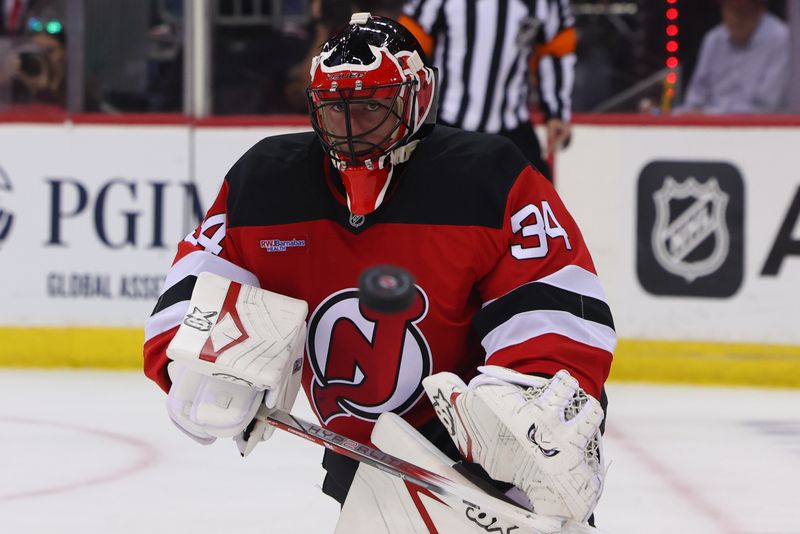 Oct 22, 2024; Newark, New Jersey, USA; New Jersey Devils goaltender Jake Allen (34) defends his net against the Tampa Bay Lightning during the first period at Prudential Center. Mandatory Credit: Ed Mulholland-Imagn Images