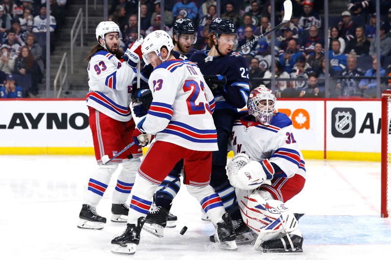 Oct 30, 2023; Winnipeg, Manitoba, CAN; New York Rangers defenseman Adam Fox (23) and Winnipeg Jets center Mason Appleton (22) look for a bouncing puck in front of Rangers goaltender Igor Shesterkin (31) in the second period at Canada Life Centre. Mandatory Credit: James Carey Lauder-USA TODAY Sports