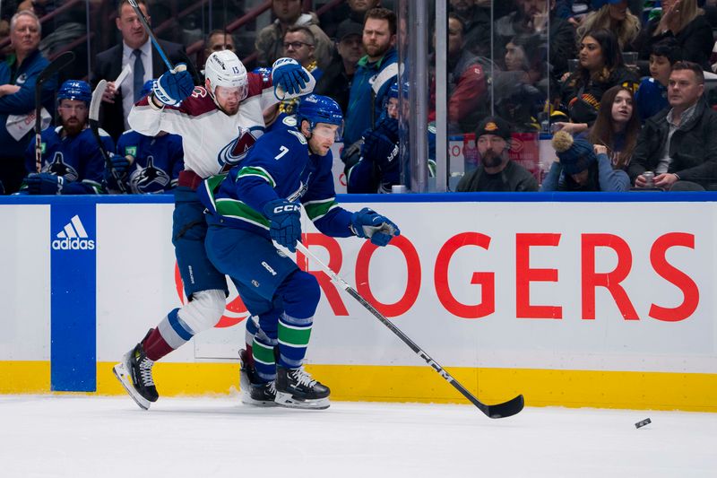 Mar 13, 2024; Vancouver, British Columbia, CAN; Vancouver Canucks defenseman Carson Soucy (7) checks Colorado Avalanche forward Valeri Nichushkin (13) in the first period at Rogers Arena. Mandatory Credit: Bob Frid-USA TODAY Sports