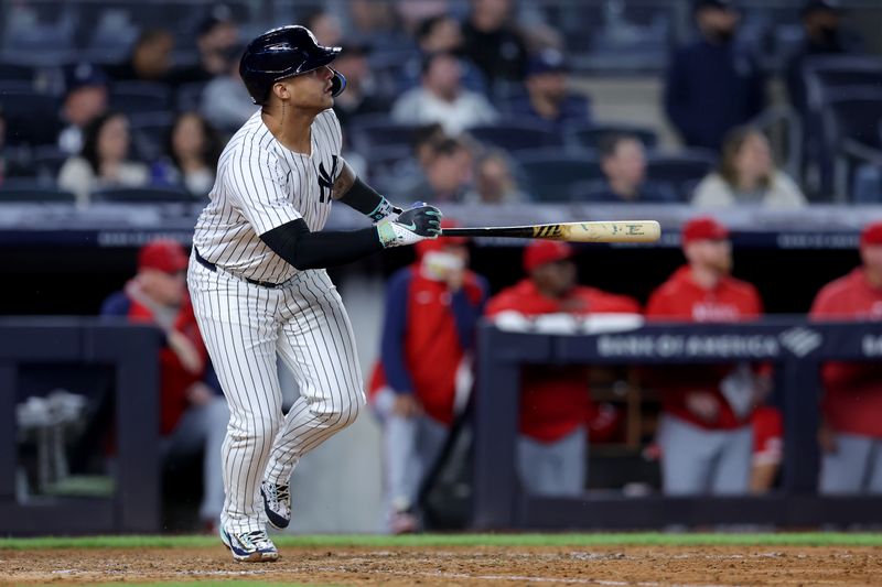 Aug 7, 2024; Bronx, New York, USA; New York Yankees second baseman Gleyber Torres (25) follows through on an RBI sacrifice fly against the Los Angeles Angels during the fourth inning at Yankee Stadium. Mandatory Credit: Brad Penner-USA TODAY Sports