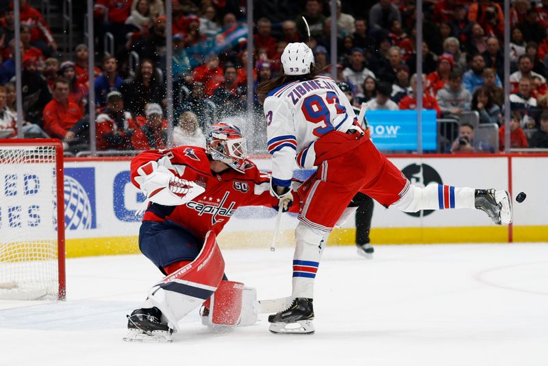 Jan 4, 2025; Washington, District of Columbia, USA; Washington Capitals goaltender Logan Thompson (48) makes a save in front ofNew York Rangers center Mika Zibanejad (93) in the second period at Capital One Arena. Mandatory Credit: Geoff Burke-Imagn Images
