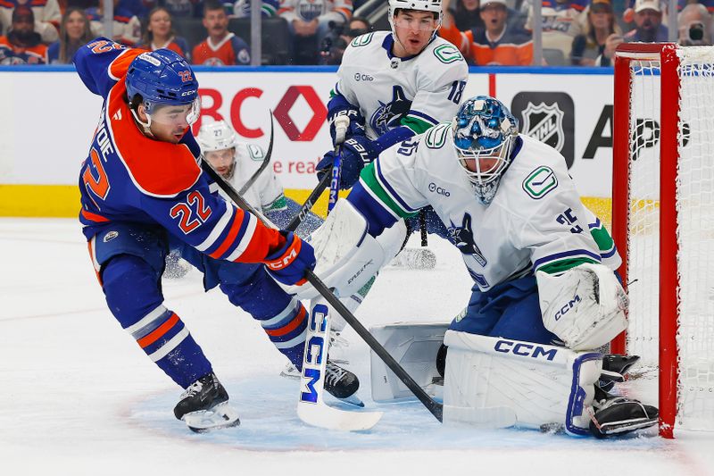 Oct 11, 2025; Edmonton, Alberta, CAN; Vancouver Canucks goaltender Thatcher Demko (35) makes a save on Edmonton Oilers forward Matt Savoie (22) during the first period at Rogers Place. Mandatory Credit: Perry Nelson-Imagn Images