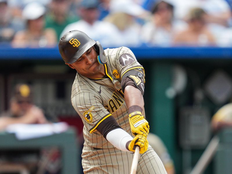 Jun 1, 2024; Kansas City, Missouri, USA; San Diego Padres designated hitter Donovan Solano (39) hits a single against the Kansas City Royals during the fourth inning at Kauffman Stadium. Mandatory Credit: Jay Biggerstaff-USA TODAY Sports