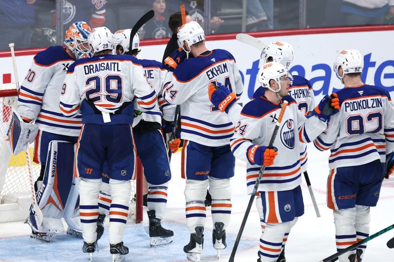 Dec 29, 2025; Winnipeg, Manitoba, CAN; Edmonton Oilers celebrate their victory over the Winnipeg Jets at Canada Life Centre. Mandatory Credit: James Carey Lauder-Imagn Images