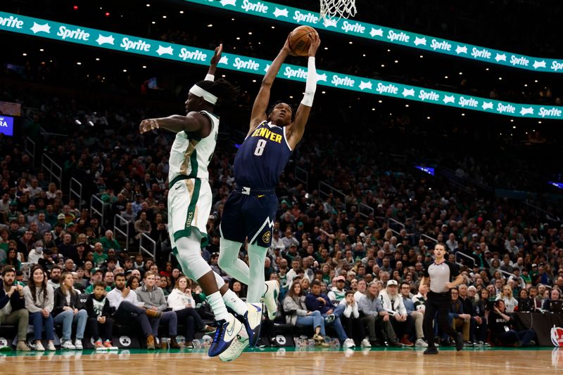 BOSTON, MA - JANUARY 19: Peyton Watson #8 of the Denver Nuggets goes to the basket past Jrue Holiday #4 of the Boston Celtics during the second quarter at TD Garden on January 19, 2024 in Boston, Massachusetts. NOTE TO USER: User expressly acknowledges and agrees that, by downloading and/or using this Photograph, user is consenting to the terms and conditions of the Getty Images License Agreement. (Photo By Winslow Townson/Getty Images)