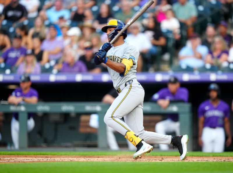 Jul 1, 2024; Denver, Colorado, USA; Milwaukee Brewers outfielder Jackson Chourio (11) hits a two run single during the fourth inning against the Colorado Rockies at Coors Field. Mandatory Credit: Ron Chenoy-USA TODAY Sports