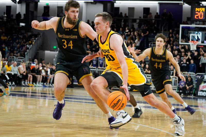 Feb 28, 2025; Evanston, Illinois, USA; Northwestern Wildcats center Matthew Nicholson (34) defends Iowa Hawkeyes forward Payton Sandfort (20) during the first half at Welsh-Ryan Arena. Mandatory Credit: David Banks-Imagn Images
