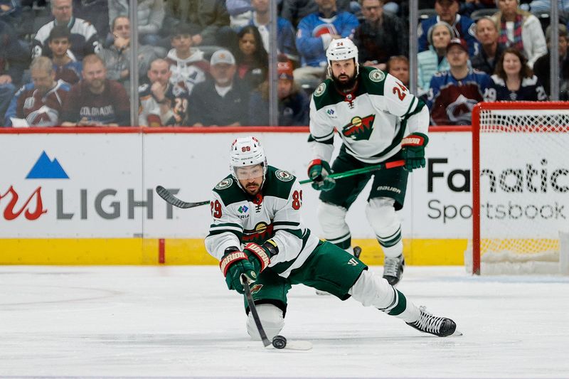 Apr 9, 2024; Denver, Colorado, USA; Minnesota Wild center Frederick Gaudreau (89) clears the puck in the first period against the Colorado Avalanche at Ball Arena. Mandatory Credit: Isaiah J. Downing-USA TODAY Sports