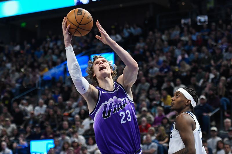 SALT LAKE CITY, UTAH - MARCH 18: Lauri Markkanen #23 of the Utah Jazz shoots over Jaden McDaniels #3 of the Minnesota Timberwolves during the second half of a game at Delta Center on March 18, 2024 in Salt Lake City, Utah. NOTE TO USER: User expressly acknowledges and agrees that, by downloading and or using this photograph, User is consenting to the terms and conditions of the Getty Images License Agreement.  (Photo by Alex Goodlett/Getty Images)