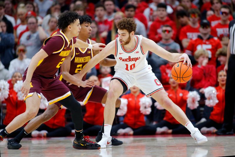 Dec 3, 2023; Columbus, Ohio, USA;  Ohio State Buckeyes forward Jamison Battle (10) dribbles the ball as Minnesota Golden Gophers guard Cam Christie (24) and guard Mike Mitchell Jr. (2) defend during the first half at Value City Arena. Mandatory Credit: Joseph Maiorana-USA TODAY Sports