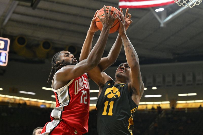 Feb 2, 2024; Iowa City, Iowa, USA; Iowa Hawkeyes guard Tony Perkins (11) and Ohio State Buckeyes guard Evan Mahaffey (12) battle for a rebound during the second half at Carver-Hawkeye Arena. Mandatory Credit: Jeffrey Becker-USA TODAY Sports