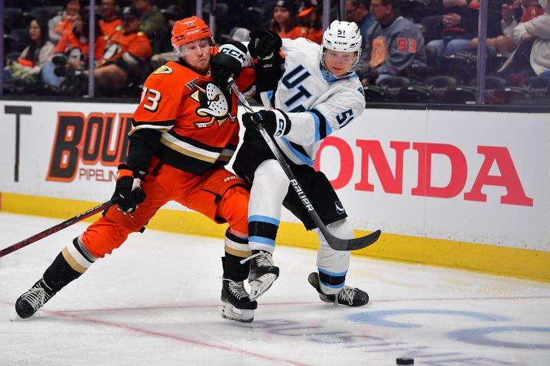 Sep 22, 2025; Anaheim, California, USA; Anaheim Ducks center Jan Mysak (73) moves in for the puck against Utah Mammoth defenseman Veeti Vaisanen (51) during the second period at Honda Center. Mandatory Credit: Gary A. Vasquez-Imagn Images