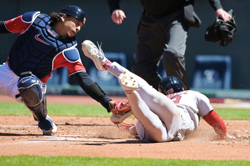 Apr 27, 2025; Cleveland, Ohio, USA; Boston Red Sox second baseman Kristian Campbell (28) scores as Cleveland Guardians catcher Bo Naylor (23) is late with the tag during the second inning at Progressive Field. Mandatory Credit: Ken Blaze-Imagn Images