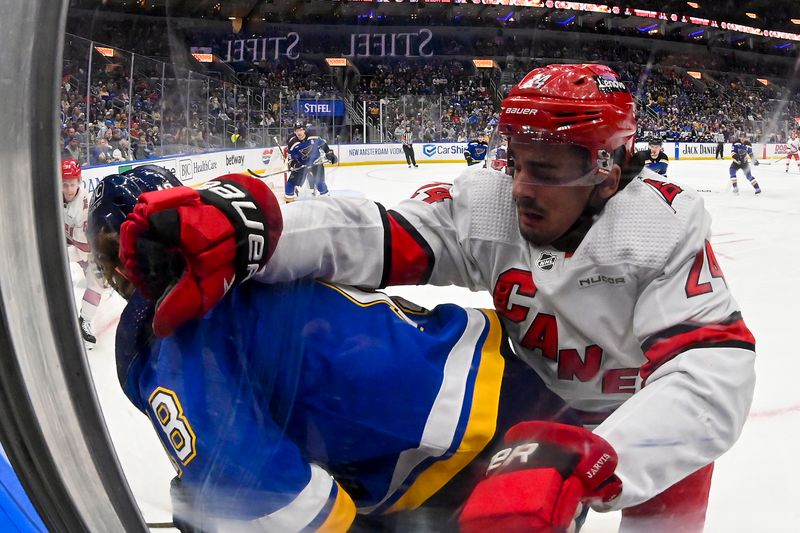 Apr 12, 2024; St. Louis, Missouri, USA;  Carolina Hurricanes center Seth Jarvis (24) checks St. Louis Blues center Robert Thomas (18) during the first period at Enterprise Center. Mandatory Credit: Jeff Curry-USA TODAY Sports