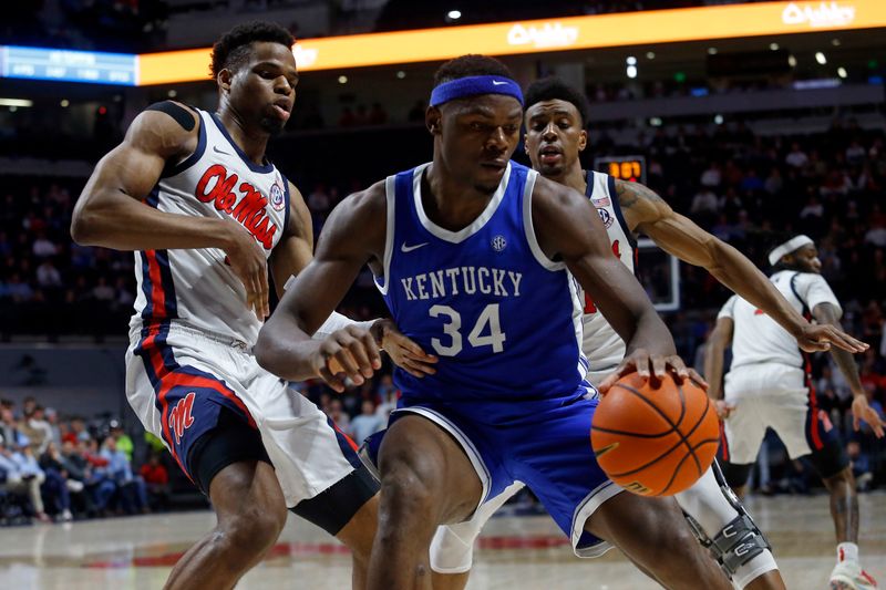 Jan 31, 2023; Oxford, Mississippi, USA; Kentucky Wildcats forward Oscar Tshiebwe (34) drives to the basket as Mississippi Rebels forward Theo Akwuba (10) defends during the first half at The Sandy and John Black Pavilion at Ole Miss. Mandatory Credit: Petre Thomas-USA TODAY Sports