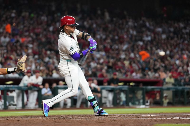 Sep 29, 2024; Phoenix, Arizona, USA; Arizona Diamondbacks second base Ketel Marte (4) hits a two run home run against the San Diego Padres during the fourth inning at Chase Field. Mandatory Credit: Joe Camporeale-Imagn Images