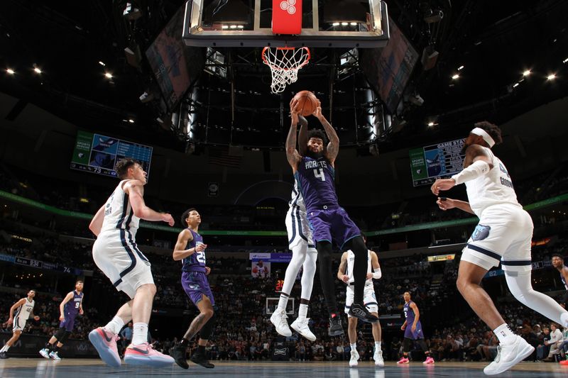 MEMPHIS, TN - MARCH 13: Nick Richards #4 of the Charlotte Hornets grabs a rebound during the game against the Memphis Grizzlies on March 13, 2024 at FedExForum in Memphis, Tennessee. NOTE TO USER: User expressly acknowledges and agrees that, by downloading and or using this photograph, User is consenting to the terms and conditions of the Getty Images License Agreement. Mandatory Copyright Notice: Copyright 2024 NBAE (Photo by Joe Murphy/NBAE via Getty Images)