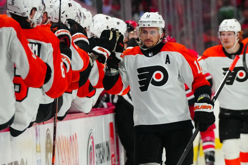 Mar 21, 2024; Raleigh, North Carolina, USA; Philadelphia Flyers right wing Travis Konecny (11) celebrates his goal against the Carolina Hurricanes during the third period at PNC Arena. Mandatory Credit: James Guillory-USA TODAY Sports