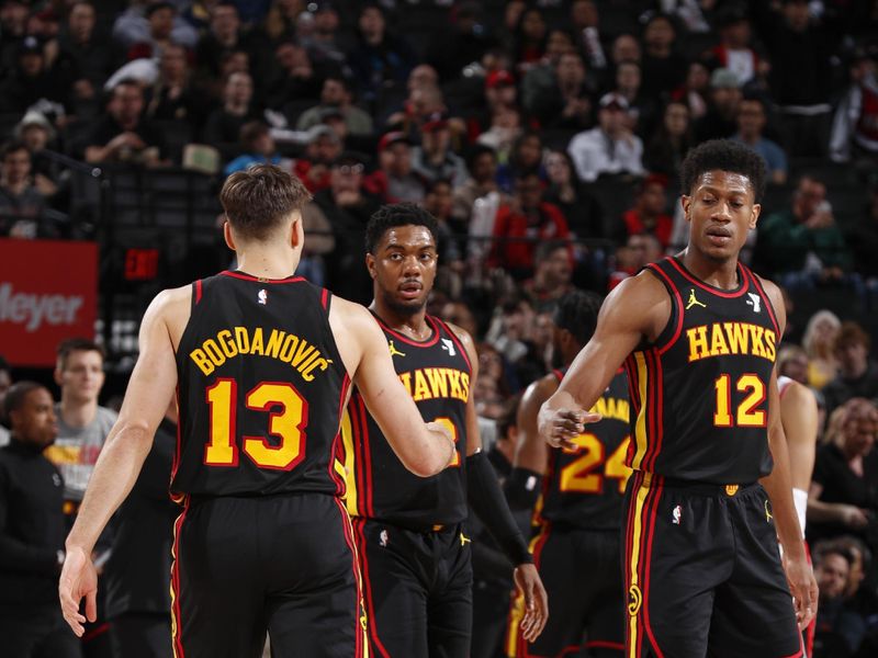 PORTLAND, OR - MARCH 13:  Bogdan Bogdanovic #13 of the Atlanta Hawks De'Andre Hunter #12 of the Atlanta Hawks & Trent Forrest #2 of the Atlanta Hawks high five during the game  on March 13, 2024 at the Moda Center Arena in Portland, Oregon. NOTE TO USER: User expressly acknowledges and agrees that, by downloading and or using this photograph, user is consenting to the terms and conditions of the Getty Images License Agreement. Mandatory Copyright Notice: Copyright 2024 NBAE (Photo by Cameron Browne/NBAE via Getty Images)