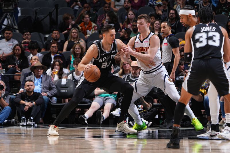 SAN ANTONIO, TX - APRIL 12: Zach Collins #23 of the San Antonio Spurs dribbles the ball during the game against the Denver Nuggets  on April 12, 2024 at the Frost Bank Center in San Antonio, Texas. NOTE TO USER: User expressly acknowledges and agrees that, by downloading and or using this photograph, user is consenting to the terms and conditions of the Getty Images License Agreement. Mandatory Copyright Notice: Copyright 2024 NBAE (Photos by Garrett Ellwood/NBAE via Getty Images)