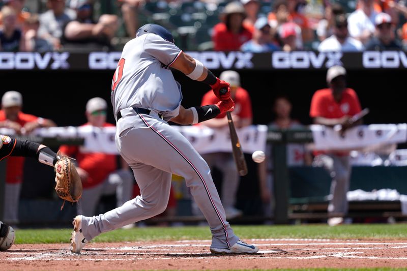 May 18, 2025; Baltimore, Maryland, USA; Washington Nationals catcher Keibert Ruiz (20) hits an RBI single against the Baltimore Orioles during the second inning at Oriole Park at Camden Yards. Mandatory Credit: Gregory Fisher-Imagn Images