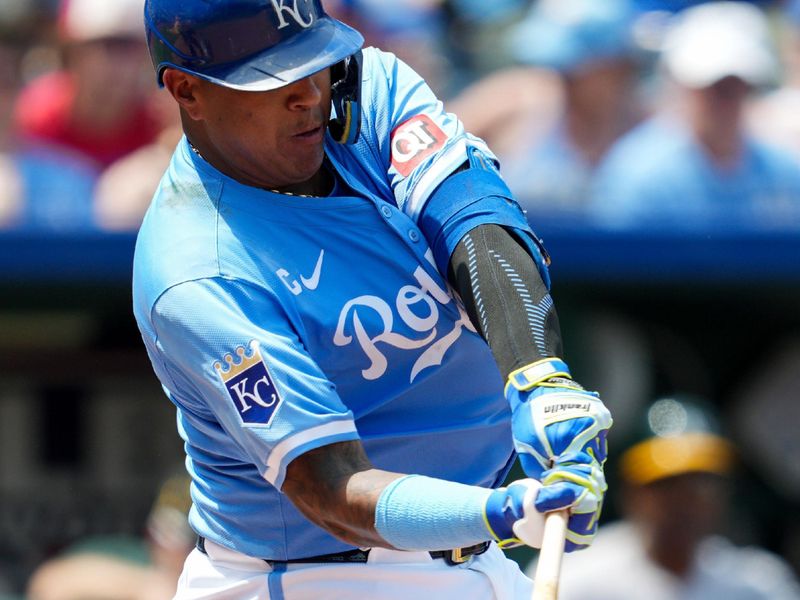 May 19, 2024; Kansas City, Missouri, USA; Kansas City Royals first baseman Salvador Perez (13) hits a single during the fifth inning against the Oakland Athletics at Kauffman Stadium. Mandatory Credit: Jay Biggerstaff-USA TODAY Sports