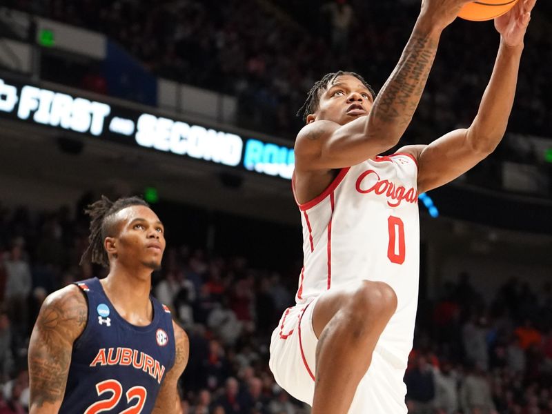 Mar 18, 2023; Birmingham, AL, USA; Houston Cougars guard Marcus Sasser (0) drives past Auburn Tigers guard Allen Flanigan (22) during the second half at Legacy Arena. Mandatory Credit: Marvin Gentry-USA TODAY Sports