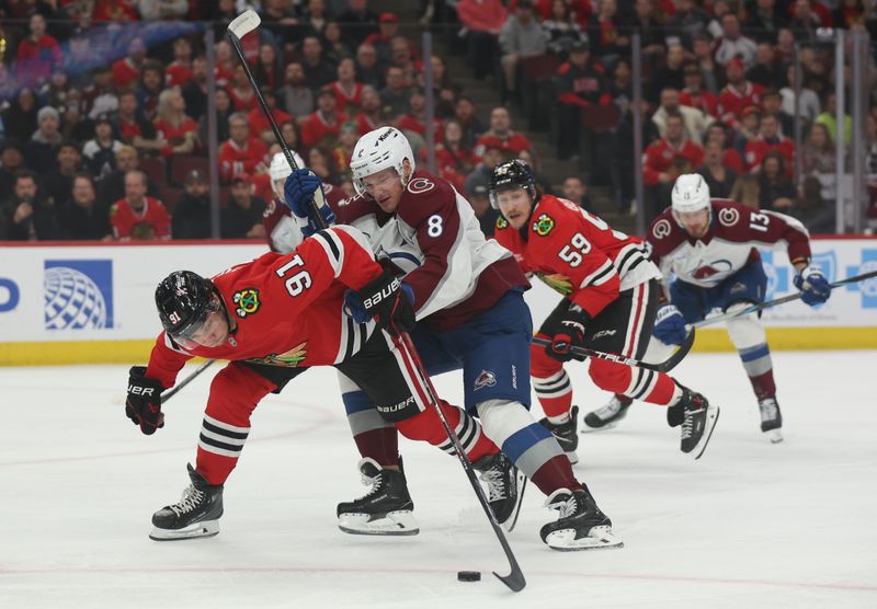 Apr 2, 2025; Chicago, Illinois, USA; Chicago Blackhawks center Frank Nazar (91) and Colorado Avalanche defenseman Cale Makar (8) battle for control of the puck during the first period at United Center. Mandatory Credit: Talia Sprague-Imagn Images