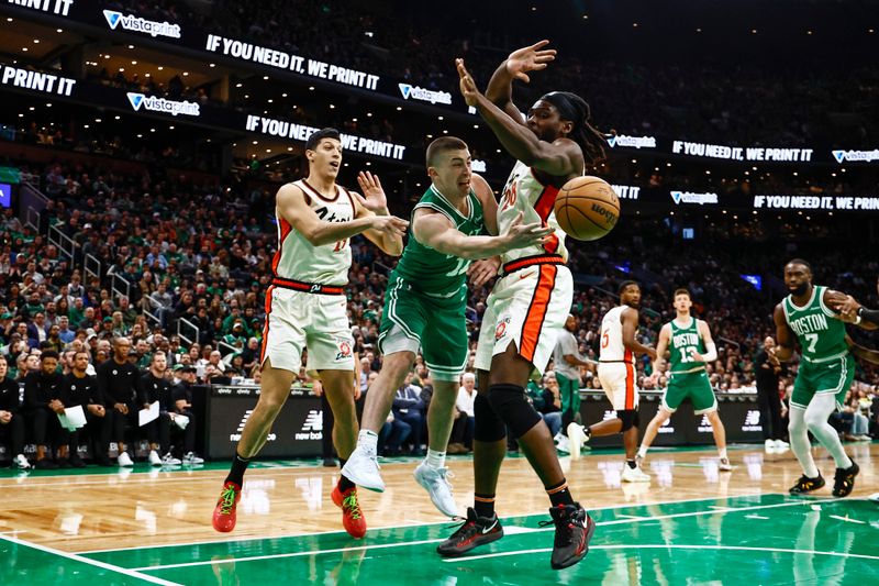 BOSTON, MA - DECEMBER 4: Payton Pritchard #11 of the Boston Celtics passes around Isaiah Stewart #28 of the Detroit Pistons during the first quarter at TD Garden on December 4, 2024 in Boston, Massachusetts. NOTE TO USER: User expressly acknowledges and agrees that, by downloading and/or using this Photograph, user is consenting to the terms and conditions of the Getty Images License Agreement. (Photo By Winslow Townson/Getty Images)