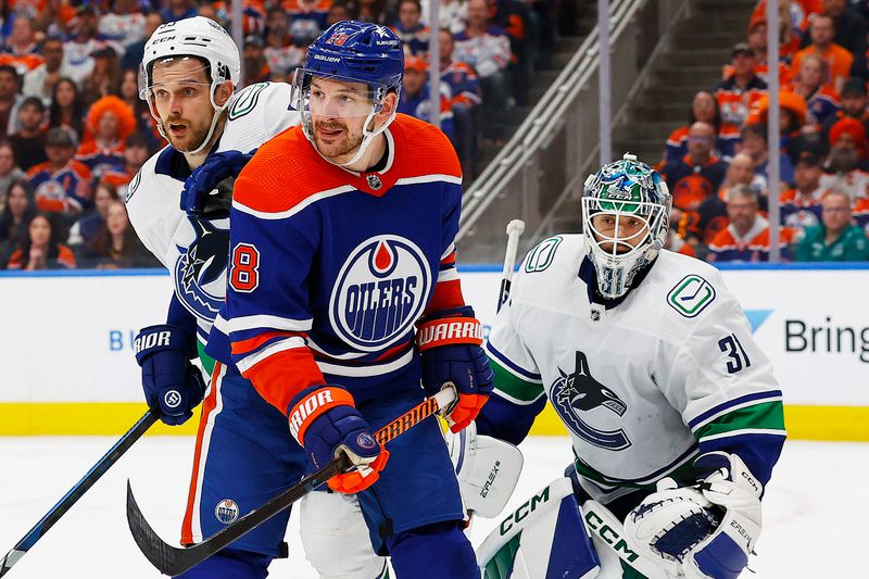 May 12, 2024; Edmonton, Alberta, CAN; Edmonton Oilers forward Zach Hyman (18) tries to screen Vancouver Canucks goaltender Arturs Silovs (31) during the third period in game three of the second round of the 2024 Stanley Cup Playoffs at Rogers Place. Mandatory Credit: Perry Nelson-USA TODAY Sports