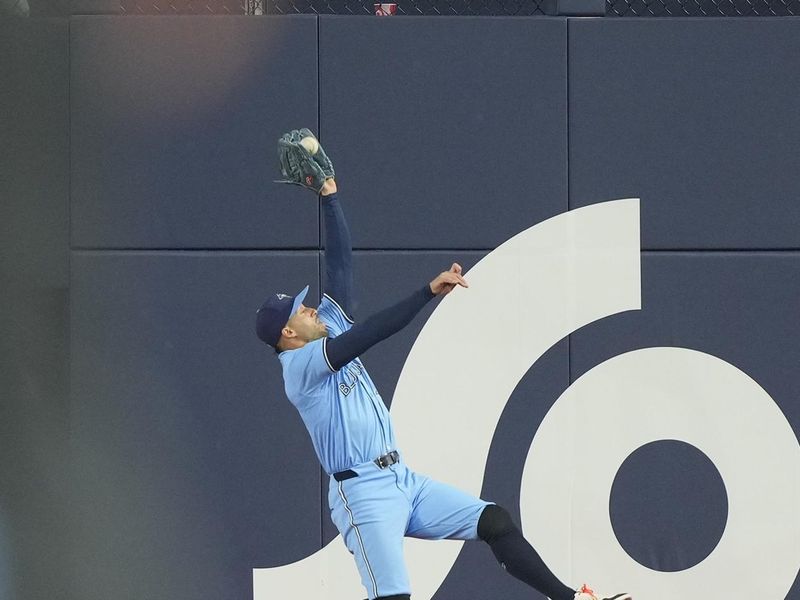 Apr 28, 2024; Toronto, Ontario, CAN; Toronto Blue Jays right fielder George Springer (4) makes a catch of a fly ball hit by Los Angeles Dodgers first baseman Freddie Freeman (5) during the fourth inning at Rogers Centre. Mandatory Credit: John E. Sokolowski-USA TODAY Sports