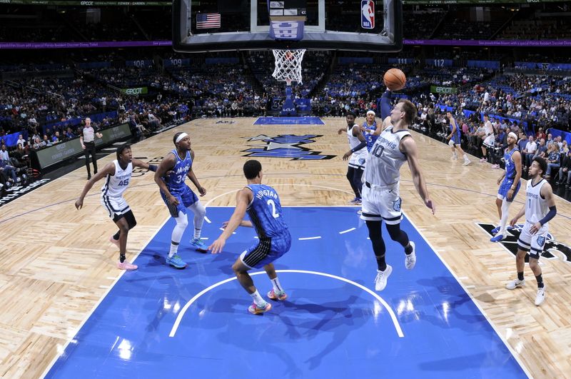 ORLANDO, FL - MARCH 30: Luke Kennard #10 of the Memphis Grizzlies rebounds the ball during the game against the Orlando Magic on March 30, 2024 at the Kia Center in Orlando, Florida. NOTE TO USER: User expressly acknowledges and agrees that, by downloading and or using this photograph, User is consenting to the terms and conditions of the Getty Images License Agreement. Mandatory Copyright Notice: Copyright 2024 NBAE (Photo by Fernando Medina/NBAE via Getty Images)