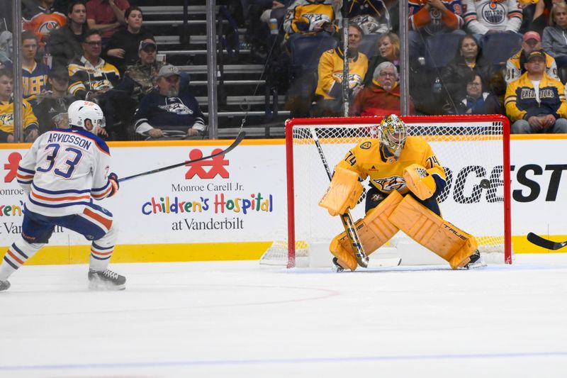 Oct 31, 2024; Nashville, Tennessee, USA;  Nashville Predators goaltender Juuse Saros (74) blocks the shot of Edmonton Oilers left wing Viktor Arvidsson (33) during the third period at Bridgestone Arena. Mandatory Credit: Steve Roberts-Imagn Images