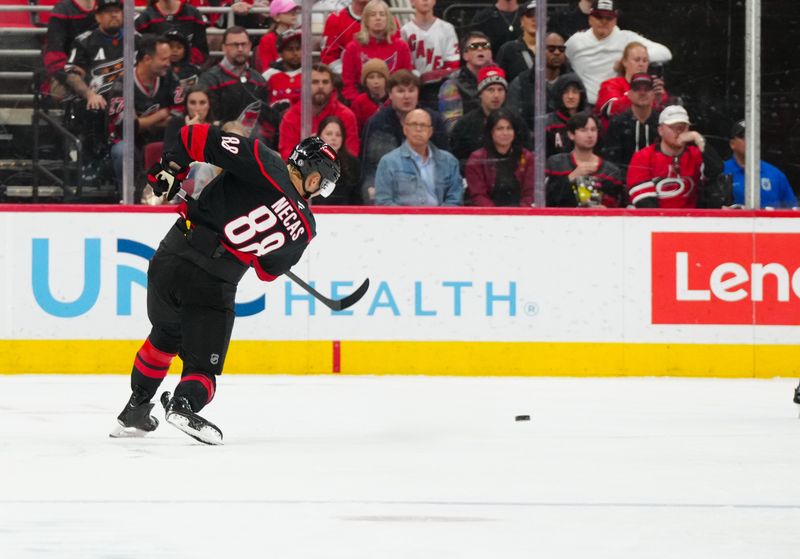 Nov 3, 2024; Raleigh, North Carolina, USA;  Carolina Hurricanes center Martin Necas (88) takes a shot against the Washington Capitals during the second period at Lenovo Center. Mandatory Credit: James Guillory-Imagn Images