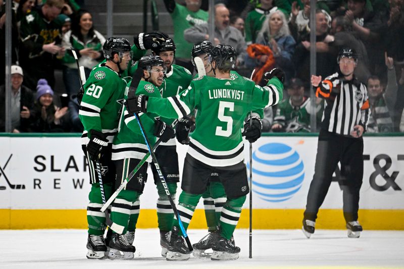 Feb 29, 2024; Dallas, Texas, USA; Dallas Stars center Logan Stankoven (11) and left wing Jamie Benn (14) and defenseman Ryan Suter (20) and center Wyatt Johnston (53) celebrates a goal scored by Stankoven against the Winnipeg Jets during the first period at the American Airlines Center. Mandatory Credit: Jerome Miron-USA TODAY Sports