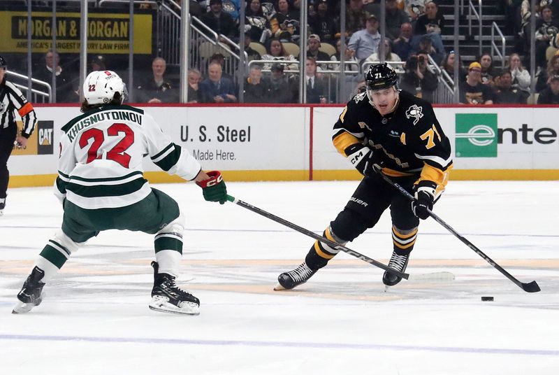 Oct 29, 2024; Pittsburgh, Pennsylvania, USA;  Pittsburgh Penguins center Evgeni Malkin (71) skates with the puck against Minnesota Wild center Marat Khusnutdinov (22) during the first period at PPG Paints Arena. Mandatory Credit: Charles LeClaire-Imagn Images