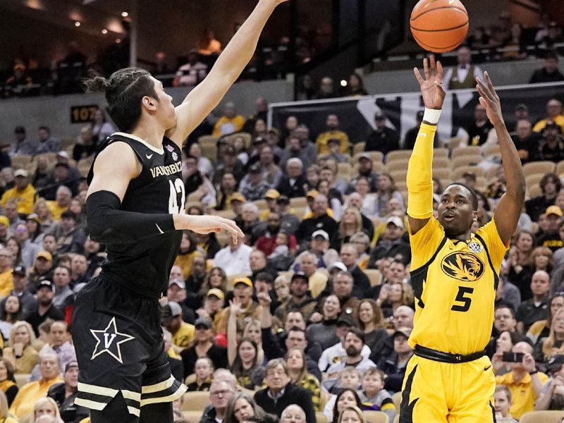 Jan 7, 2023; Columbia, Missouri, USA; Missouri Tigers guard D'Moi Hodge (5) shoots as Vanderbilt Commodores forward Quentin Millora-Brown (42) defends during the first half at Mizzou Arena. Mandatory Credit: Denny Medley-USA TODAY Sports