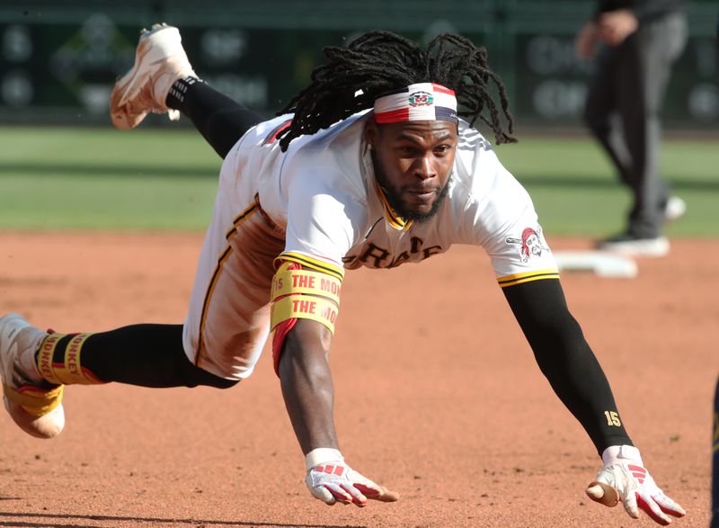 May 24, 2025; Pittsburgh, Pennsylvania, USA;  Pittsburgh Pirates center fielder Oneil Cruz (15) dives into third base with an RBI triple against the Milwaukee Brewers during the seventh inning at PNC Park. Mandatory Credit: Charles LeClaire-Imagn Images