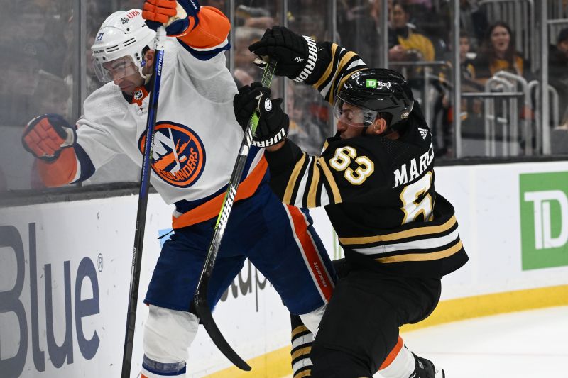 Nov 9, 2023; Boston, Massachusetts, USA; Boston Bruins left wing Brad Marchand (63) checks New York Islanders center Kyle Palmieri (21) during the third period at the TD Garden. Mandatory Credit: Brian Fluharty-USA TODAY Sports