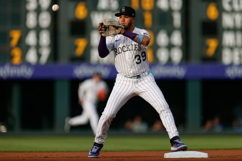 Aug 5, 2025; Denver, Colorado, USA; Colorado Rockies second baseman Thairo Estrada (39) turns the first half of a double play in the first inning against the Toronto Blue Jays at Coors Field. Mandatory Credit: Isaiah J. Downing-Imagn Images