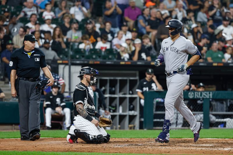 Aug 9, 2023; Chicago, Illinois, USA; New York Yankees designated hitter Giancarlo Stanton (27) crosses home plate after hitting a solo home run against the Chicago White Sox during the seventh inning at Guaranteed Rate Field. Mandatory Credit: Kamil Krzaczynski-USA TODAY Sports