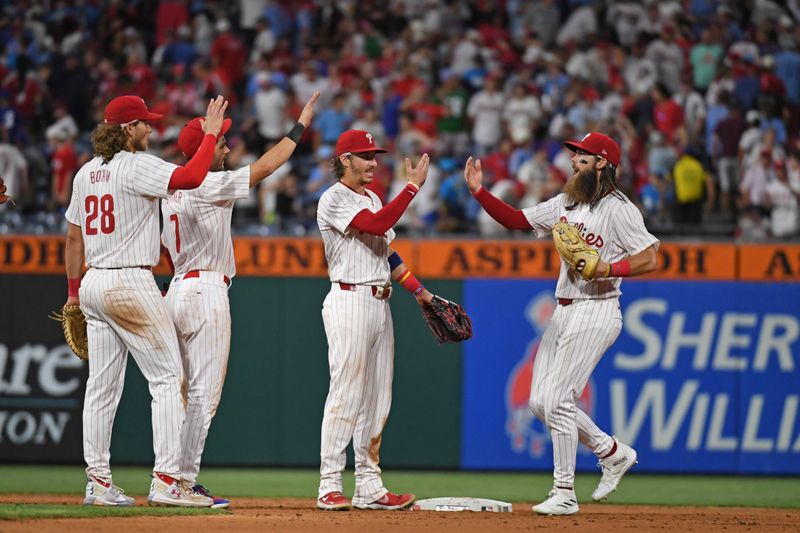 Jul 10, 2024; Philadelphia, Pennsylvania, USA; Philadelphia Phillies third base Alec Bohm (28), shortstop Trea Turner (7), second base Bryson Stott (5) and outfielder Brandon Marsh (16) celebrate win  against the Los Angeles Dodgers at Citizens Bank Park. Mandatory Credit: Eric Hartline-USA TODAY Sports