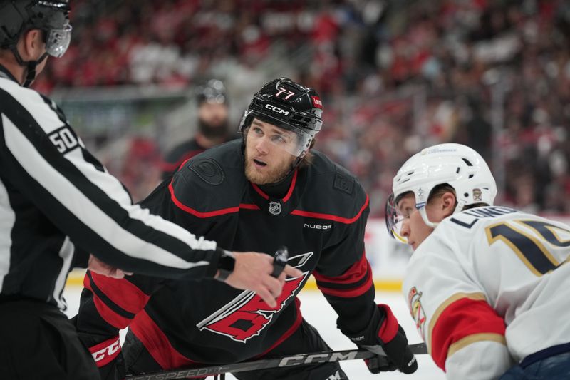 May 28, 2025; Raleigh, North Carolina, USA; Carolina Hurricanes forward Mark Jankowski (77) faces off against Florida Panthers forward Anton Lundell (15) during the third period in game five of the Eastern Conference Final of the 2025 Stanley Cup Playoffs at Lenovo Center. Mandatory Credit: James Guillory-Imagn Images