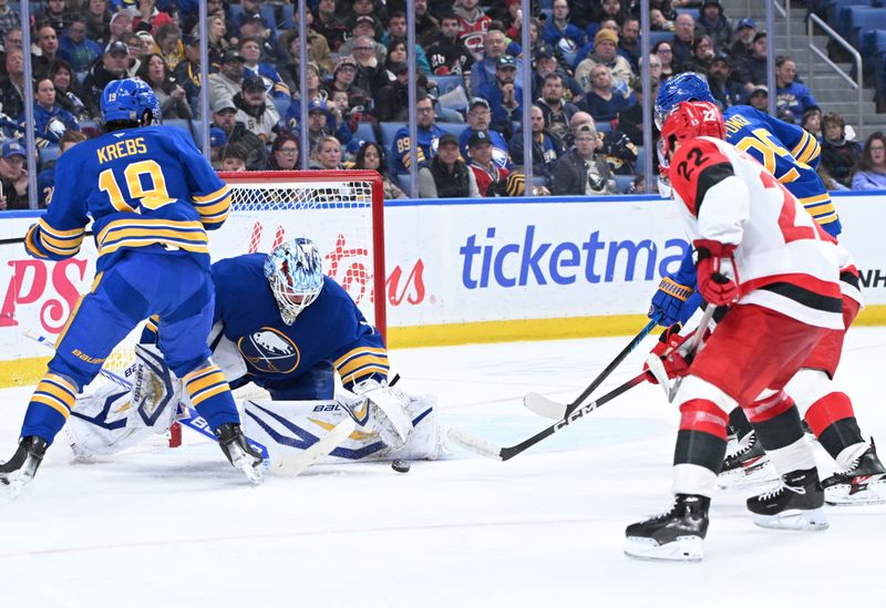 Nov 23, 2025; Buffalo, New York, USA; Buffalo Sabres goaltender Ukko-Pekka Luukkonen (1) covers a shot by Carolina Hurricanes center Logan Stankoven (22) in the third period at KeyBank Center. Mandatory Credit: Mark Konezny-Imagn Images