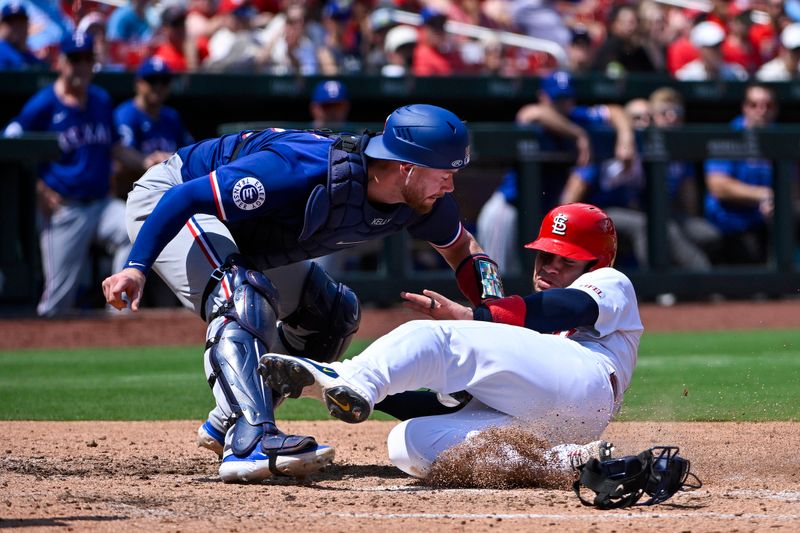 Jul 31, 2024; St. Louis, Missouri, USA;  St. Louis Cardinals designated hitter Willson Contreras (40) slides in at home and scores as Texas Rangers catcher Carson Kelly (18) drops the ball during the fifth inning at Busch Stadium. Mandatory Credit: Jeff Curry-USA TODAY Sports