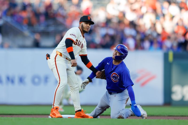 Jun 24, 2024; San Francisco, California, USA; Chicago Cubs outfielder Seiya Suzuki (27) is tagged out by San Francisco Giants second base Thairo Estrada attempting to steal a base during the first inning at Oracle Park. All Giants players wore the number 24 in honor of Giants former player Willie Mays. Mandatory Credit: Sergio Estrada-USA TODAY Sports